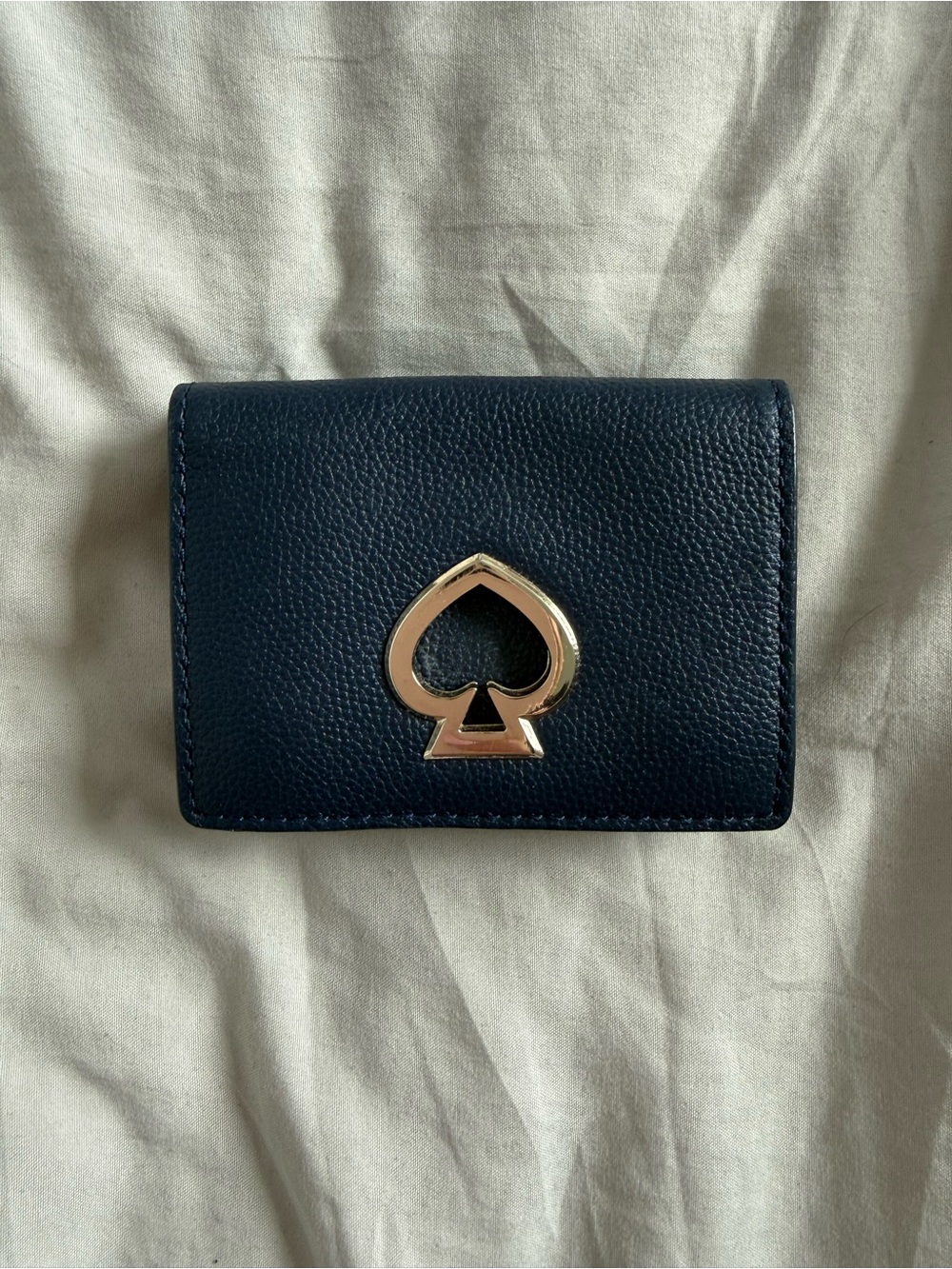 kate spade navy leather card holder with gold spade emblem